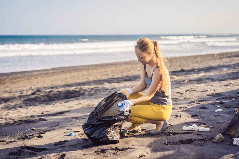 woman cleaning beach in mauritius